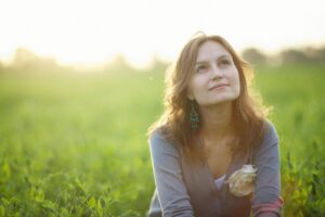 Woman in meadow sitting in a mindful meditation. 