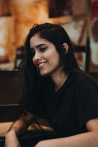 Woman mindfully reflecting on emotions while sitting in a cafe.