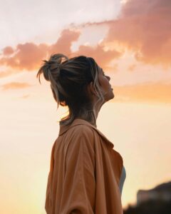 Person hopefully looking up at the sky as they consider how anxiety counseling can help. 