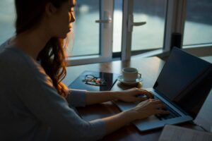 Photo of person on computer checking on election results and researching how to manage election anxiety through finding counseling.