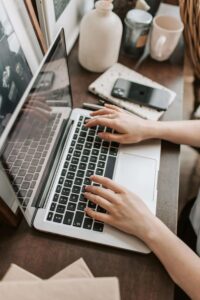 Person at a desk checking their internet connection for online therapy