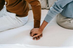 Zoomed in picture on couples holding hands as they prepare to reach out for couples counseling