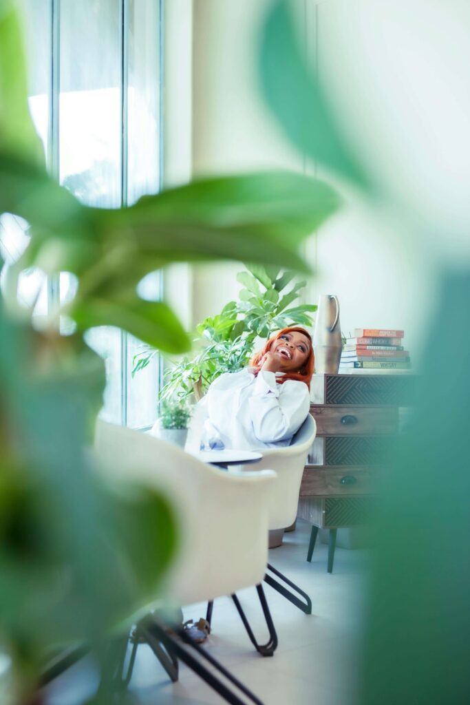 A woman sits, creating space for emotional release and reflection after Brainspotting therapy session