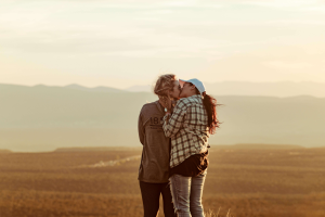 Couple outdoors kissing rekindling intimacy through tools learned in couples counseling in Colorado