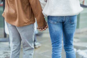 Couple holding hands as they learn to reconnect with the help of marriage therapy in Colorado