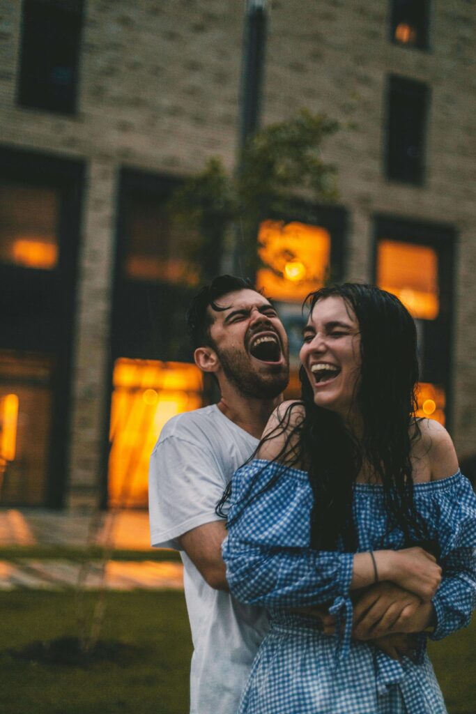 Couples hugging in the rain happy that they worked on their communication with couples counseling in OKC.