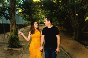 Couple walking together outdoors in a peaceful park at sunset while practicing mindful connection and emotional intimacy exercises recommended by a couples therapist in OKC.