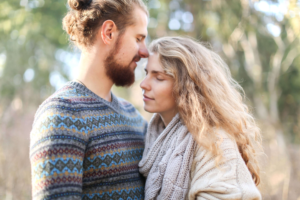 Couple looking at each other in the mountains working on connection as they learn to create healthy conflict with the help of couples counseling in Colorado