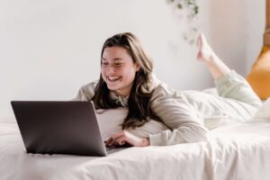 Person cozied up in bed ready for online therapy in Colorado