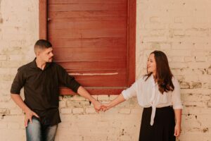 Man and woman reaching towards each other after couples counseling in Edmond