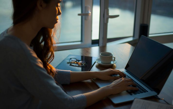 Photo of person on computer checking on election results and researching how to manage election anxiety through finding counseling.