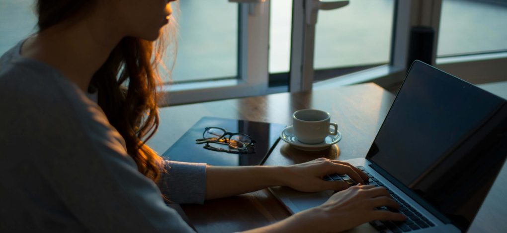 Photo of person on computer checking on election results and researching how to manage election anxiety through finding counseling.