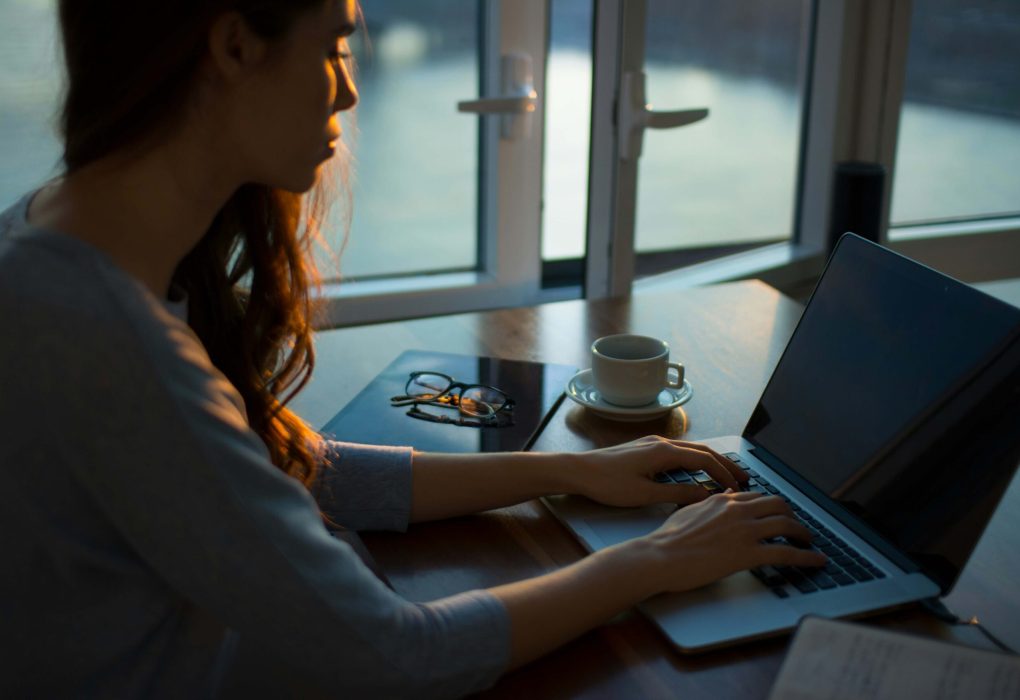 Photo of person on computer checking on election results and researching how to manage election anxiety through finding counseling.