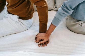 Zoomed in picture on couples holding hands as they prepare to reach out for couples counseling