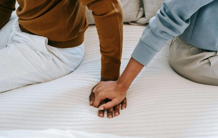 Zoomed in picture on couples holding hands as they prepare to reach out for couples counseling