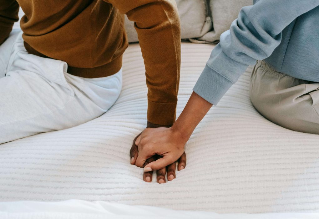 Zoomed in picture on couples holding hands as they prepare to reach out for couples counseling